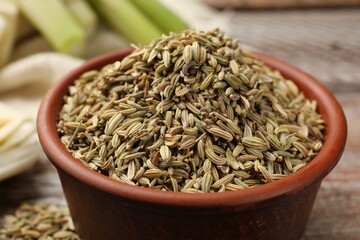 Fennel seeds in bowl on table, closeup