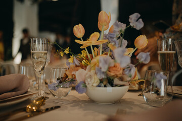 Elegant, romantic table setting for indoor spring wedding reception. Luxury wedding table...