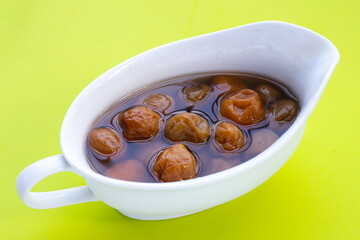 Pickled plums on white background.