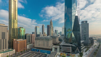 Fototapeta premium Dubai International Financial district aerial night to day timelapse. Panoramic view of business office towers.