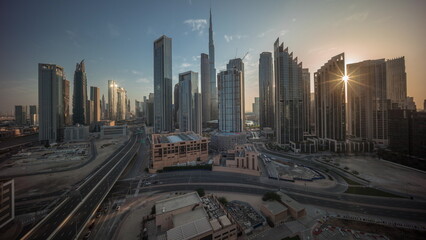 Aerial view of Dubai Downtown skyline during sunrise with many towers timelapse.