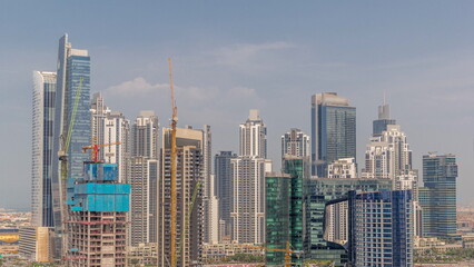 Obraz premium Cityscape with skyscrapers of Dubai Business Bay and water canal aerial timelapse.