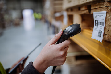 Scanner, scanning the barcodes on products in warehouse. Warehouse manager using warehouse scanning...