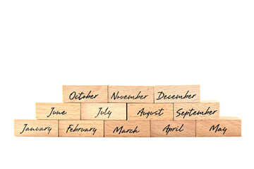 Wooden blocks with months according to calendar year. Bitcoin coin and wooden block. Concept of financial trends. Names of months are marked on wooden blocks.