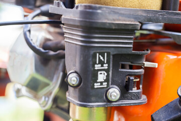 Carburetor with a cold start damper on a walk-behind tractor, close-up - obrazy, fototapety, plakaty