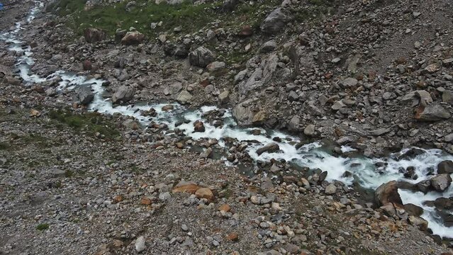 The beautiful shot of the Mandakini River flowing through the mountains in Kedarnath Temple, Uttarakhand, India, Foothills of the Himalayas.