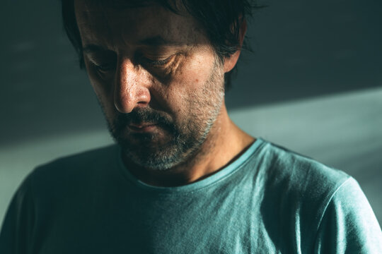Midlife crisis of middle aged man. Closeup portrait of man in 40s in a depressed state of mind, sad and hopeless.