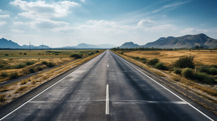 A Long Empty Road Surrounded By Fields and Mountain Hills