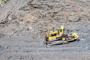 Heavy machinery in the process of mountain road construction works in Saudi Arabia