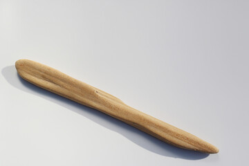 wooden stick shaped by river on white background