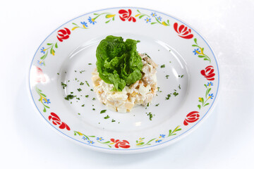 russian salad on the white plate