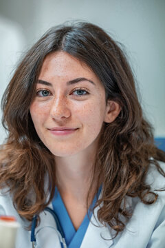 Young female doctor in uniform with stethoscope looking at camera