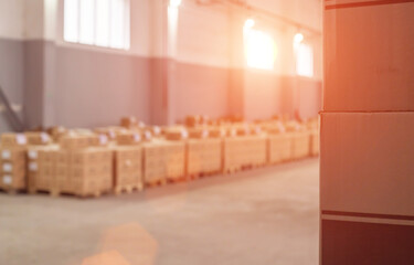 Tobacco and alcohol products in cardboard boxes in a warehouse against a sunset background....