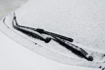 close up of car windshield covered by snow