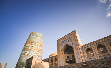 The Kalta Minar and Madrasah of Muhammad Amin Khan is lined with mosaics and ceramic tiles in the ancient city of Khiva in Khorezm, medieval architecture