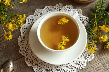 A cup of herbal tea with fresh St. John's wort flowers