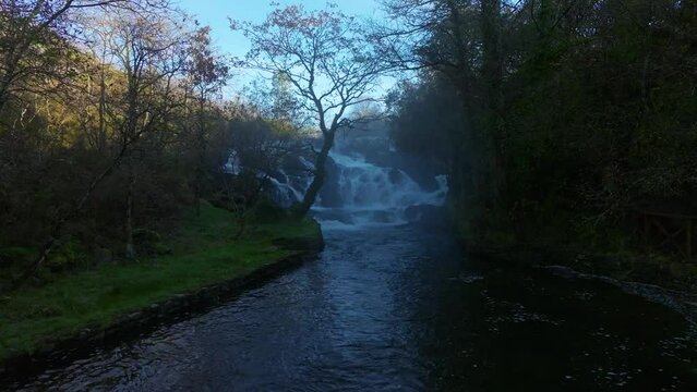 Forest River With Santa Comba Waterfall During Foggy Morning In A Coruna, Spain. Aerial Forward Shot