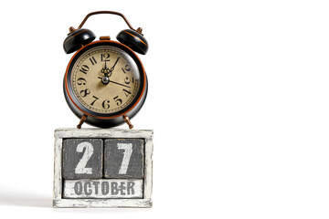 October 27 on wooden calendar with alarm clock white background.