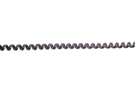 Black spiral telephone cord isolated on white background.