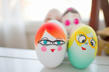 Easter eggs painted with the funniest faces, colorfully painted with quirky cartoonish eyes and expressions, family participation and fun crafting together concept.