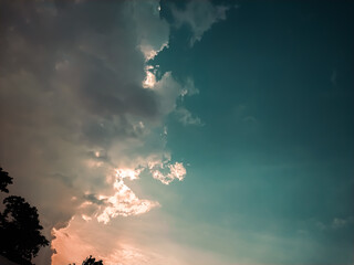 Beautiful sky with clouds at sunset. Natural background. Toned.