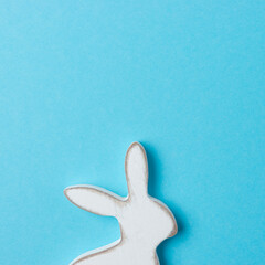 Easter bunny decoration on blue background. Minimal Easter concept.