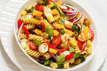 fusilli salad with mozzarella, veggies in a bowl