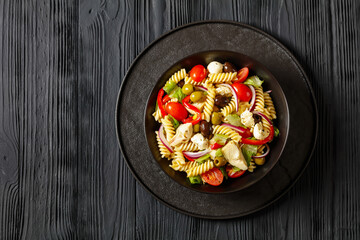 fusilli salad with mozzarella, veggies in a bowl