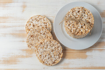 Crunchy rice cakes on white wooden table. Food background.