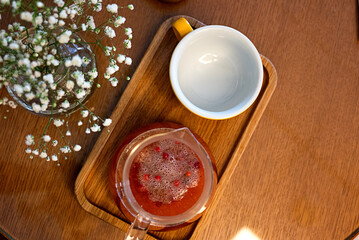 Tea from viburnum in the glass cup with cinnamon and star anise. Close-up. Selective focus.