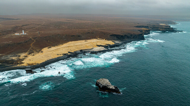 Aerial of the wild coastline with basalt pools on the Atlantic coastline, Dombe Grande, Namibre, Angola