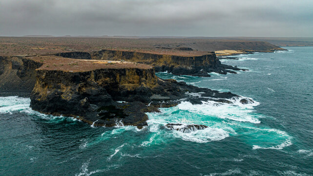 Aerial of the wild coastline with basalt pools on the Atlantic coastline, Dombe Grande, Namibre, Angola
