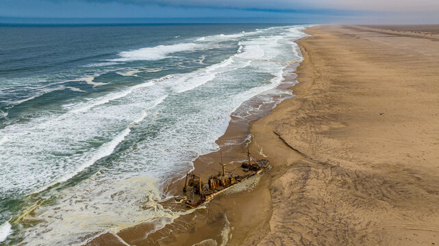 Aerial of a shipwreck on a beach in the Iona National Park, Namibe, Angola