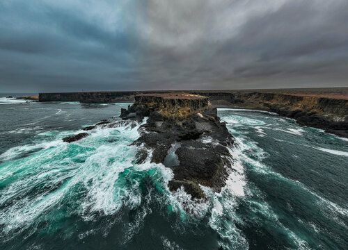 Aerial of the wild coastline with basalt pools on the Atlantic coastline, Dombe Grande, Namibre, Angola