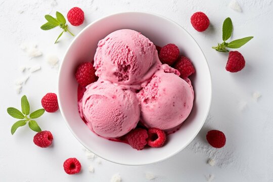 Raspberry ice cream in white bowl overhead shot 