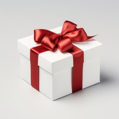 white cardboard gift box with a red ribbon and bow on