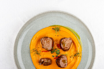 Pork loin on mashed yams. Isolated image