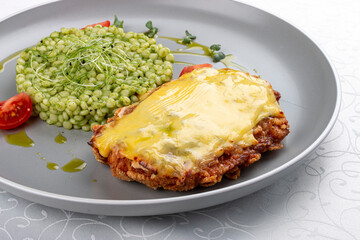 Chicken schnitzel under cheese with pittitimus. Isolated image