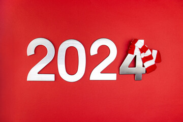Composition with the number 2024 in silver, metal on a red monochrome background