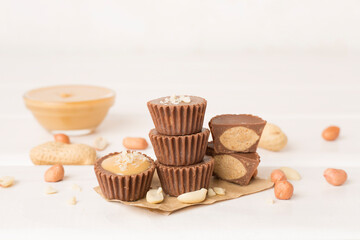 Fototapeta na wymiar Tasty chocolate peanut butter cups on wooden table
