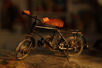 A Vintage Black Indian Iron Bicycle or cycle toy standing on a dirty glass with selective focus 