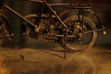A Vintage Black Indian Iron Bicycle or cycle toy standing on a dirty glass with selective focus, closeup shot