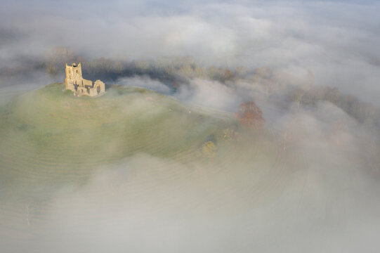 Aerial image of St Michael's Church on Burrow Mump, surrounded by a blanket of mist, Burrowbridge, Somerset, England, United Kingdom, Europe