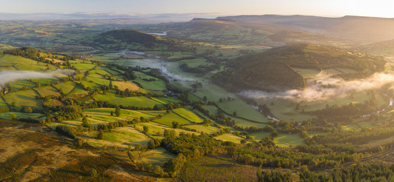 Aerial view by drone of mist floating over the Usk Valley at dawn, Brecon Beacons National Park, Powys, Wales, United Kingdom, Europe