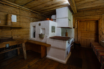 Ancient traditional clay stove in ancient wooden house in Lviv region