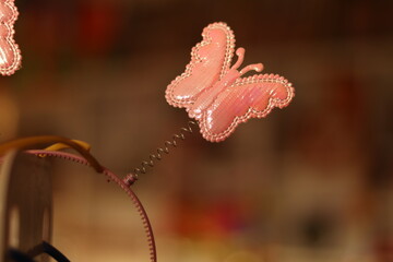 A Pink Butterfly angel or hair band attached with spring