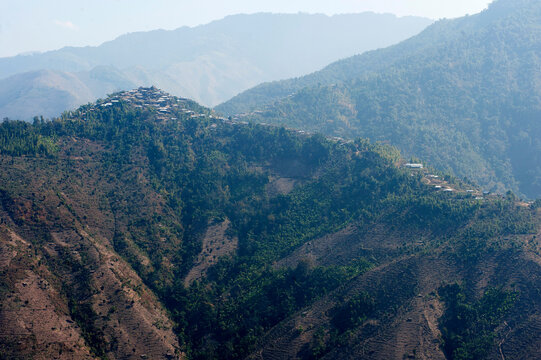 One of the countless hilltop Naga villages in the verdant Naga hills, Baptist church at its peak, Nagaland, India