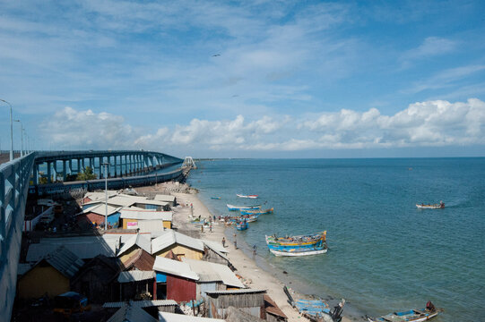 Fisherman community under Pamban Bridge with colourful fishing boats, Pamban Straits, Rameshwaram, Tamil Nadu, India