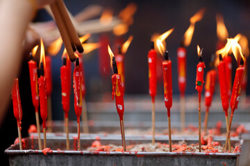 Chinese man burning incense and praying to a prosperous future, Guan Di Chinese Taoist Temple, Kuala Lumpur, Malaysia