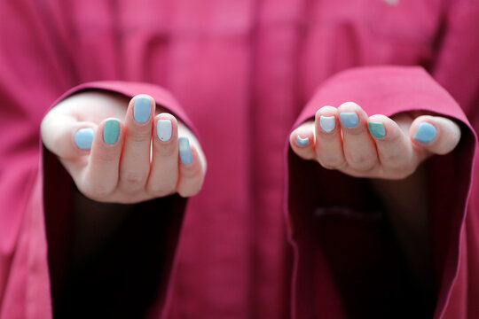 Close-up of hands of Muslim woman praying, Putra Mosque (Masjid Putra), Putrajaya, Malaysia